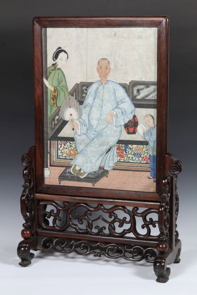 Chinese 19th C. Table Screen: Table Screen, China, 19th century, with a portrait of a man resting his feet on a footstool and one elbow on a jardinière, his wife and child to his left and right, on a rosewood stand carved with fo