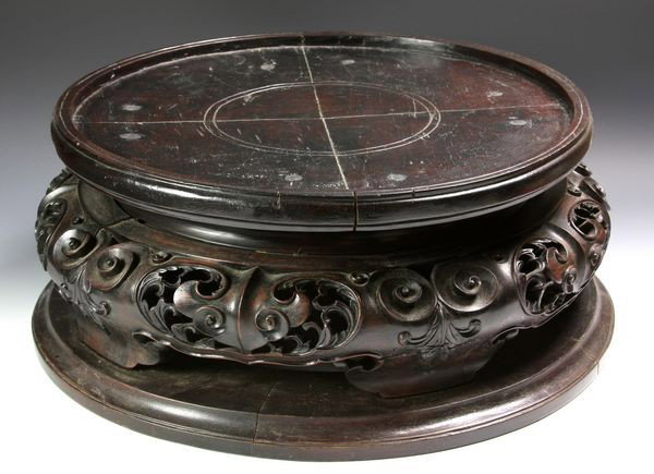 Chinese 19th C. Vase Stand: Wood Vase Stand, China, 19th century, the large circular tiered form with a carved and pierced center section, 7" high x 15 1/2" diameter, cracks. Originally acquired by C.T. Loo & Co. of New York, NY