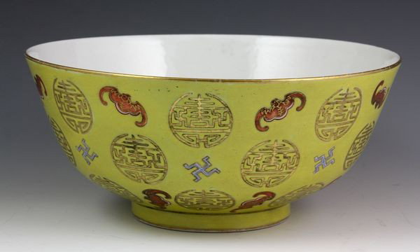Chinese Early 20th C. Famille Rose Bowl: Famille Rose Bowl, China, early 20th century, decorated with bats and symbols of longevity on a yellow ground, Guangxu mark on base, 4 3/8" high x 7 4/8" diameter.