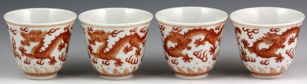 Chinese Set of Early 20th C. Wine Cups: Set of Four Wine Cups, China, early 20th century, decorated with red dragons amid flames, six-character Guangxu mark on base, 2" high x 2 1/2" diameter, one minor repair on rim.