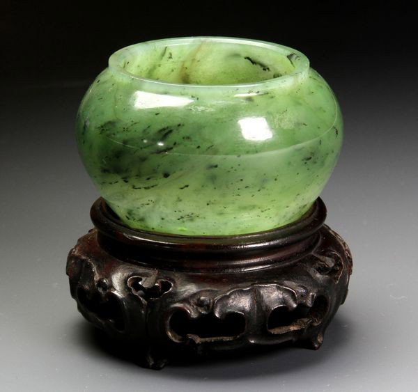 Chinese 19th C. Jade Scholar's Water Pot: Jade Scholar's Water Pot, China, 19th century, with a custom carved wood stand, 1 1/4" high x 2" diameter. Originally acquired by C.T. Loo & Co. of New York, NY and Paris, France. This collection was 
