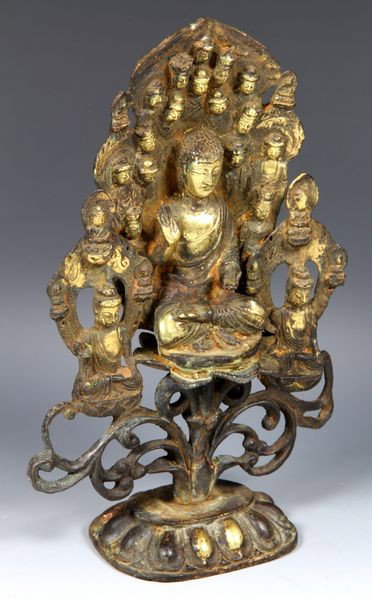 Chinese Liao Dynasty Buddhist Figure: Buddhist Figure, China, Liao Dynasty (907 - 1125 AD) or later, parcel-gilt bronze, a central Buddha sits on a lotus base with right hand in Abhaya mudra, surrounded by many other figures and faces, su