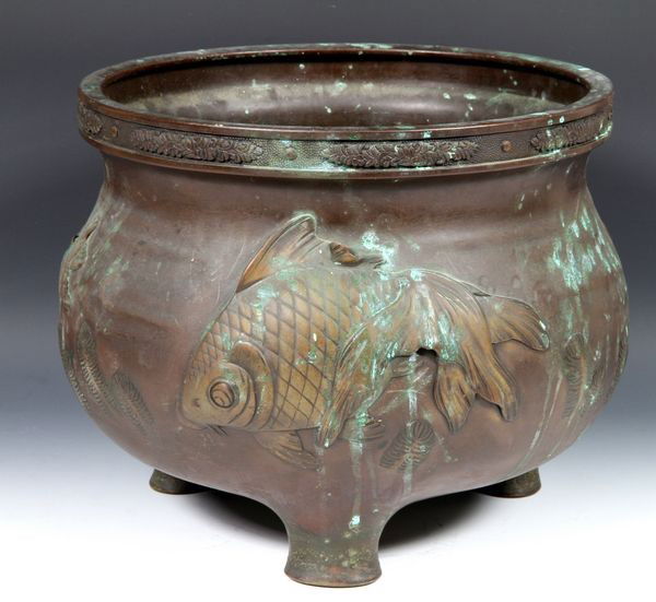 Japanese 19th C. Bronze Urn: Bronze Urn, Japan, 19th century, the bulbous body cast with a raised koi fish design, on tripod feet, marked on base, 10" high x 12" diameter.