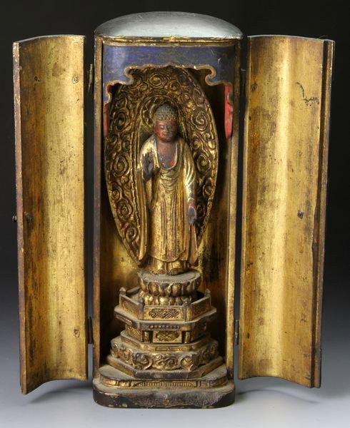 Japanese Edo Period Buddha: Figure of the Buddha, Japan, Edo Period (1603-1867), approximately 1700, standing on a lotus pedestal, in a black lacquered case, 8 1/2" high x 2 1/2" wide.