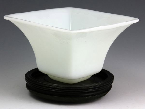 Chinese Peking Glass Vase: Peking Glass Vase, China, white glass square form with flared mouth, on wood stand, 2 1/2" high x 4" diameter. Originally acquired by C.T. Loo & Co. of New York, NY and Paris, France. This collection 