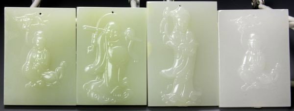 Four Chinese Jade Pendants: Four Jade Pendants, China, each rectangular form carved with a Buddhist figure, 2 1/2" x 1 3/4".
