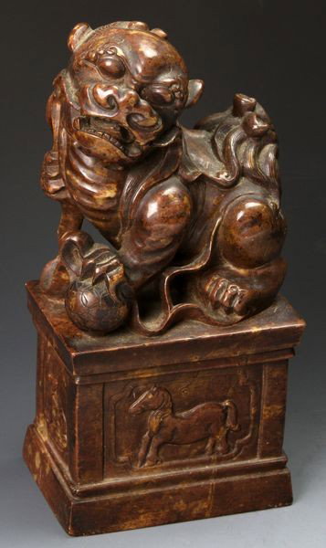 Chinese Temple Dog: Temple dog on base, China, 19th century, brown soapstone, 7 1/2" high x 3 1/2" wide x 2 1/2" deep.
