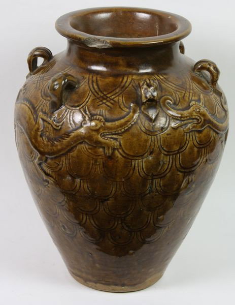 Brown Glazed Jar: Brown Glazed Jar, China, Liao Dynasty (907-1125 AD), with embossed dragon over fish scales, 9 1/2" high x 7" diameter, rim chips and hairlines.