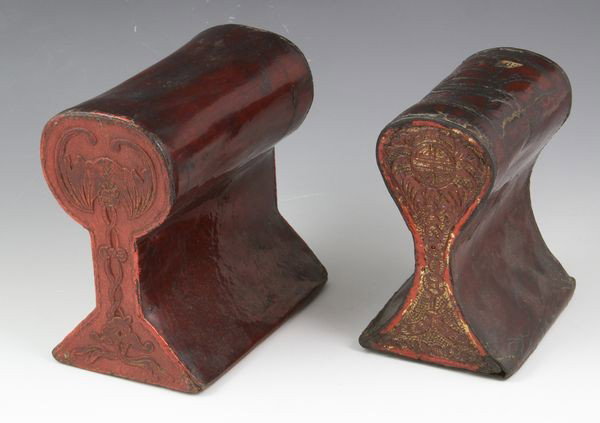 Two Chinese 19th C. Leather Pillows: Two Leather Pillows, China, 19th century, engraved with bats and symbols of prosperity, 6" high x 5 1/2" wide x 3" deep.