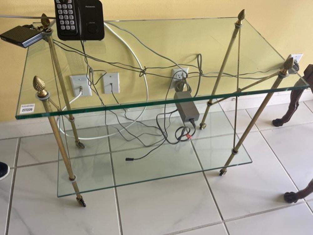 Neoclassical Brass Table with Glass Shelves: Neoclassical brass table with two glass shelves, 25" x 28" x 15".