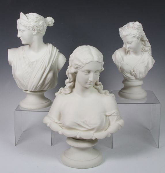 Three (3) 19th C. Parian Busts: Three (3) 19th century white Parian busts of women on several bases, tallest 12".