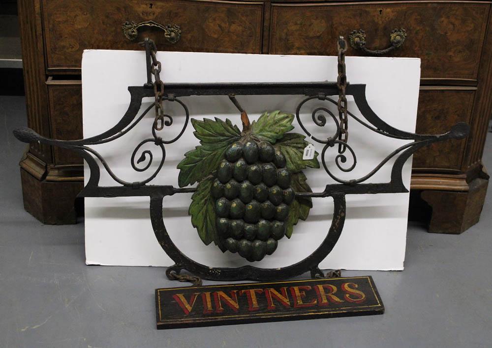 Cast Iron Vintners Trade Sign: Cast iron "Vintners" trade sign with carved and paint-decorated grape cluster, 35" H x 48" W. Provenance: Collection of Anthony's Cummaquid Inn, Yarmouthport, Massachusetts.