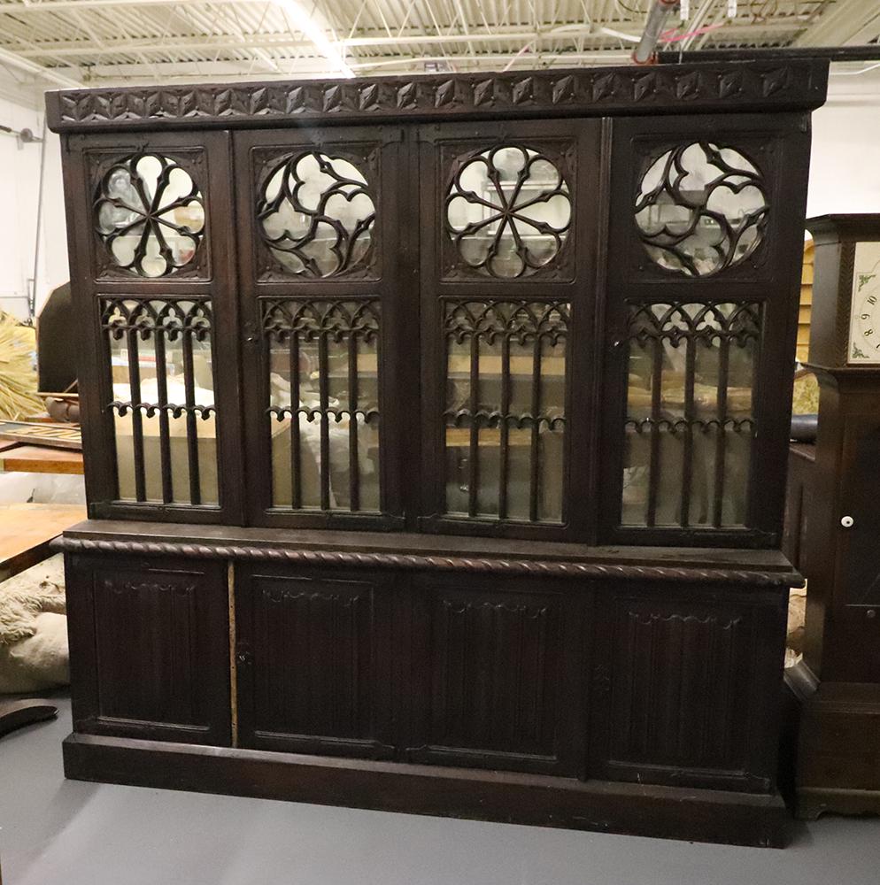 English Gothic Oak Eight Door Cupboard: English Gothic oak eight-door cupboard, four mirrored upper doors and four pleat-carved lower doors, iron hinges, with keys, 85" H x 86 1/2" W x 19" D. Good condition.
