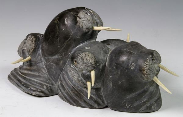 Inuit Carved Stone Group Walruses: Group of five (5) walruses with tusks, carved hardstone, circa 1975, signed "J.I.K.", 6" x 12". Small chip at one end. Purchased at Blue Nose Gallery in Yarmouth, Nova Scotia.
