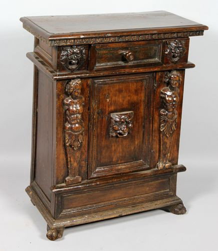 17th/18th C. Walnut Credenza: 17th/18th century Italian carved credenza cabinet with figural posts having single drawer and center door, walnut, 35" x 28 1/2" x 13 1/2". Good condition. Purchased at Waldo Pedersen's, Los Angeles.