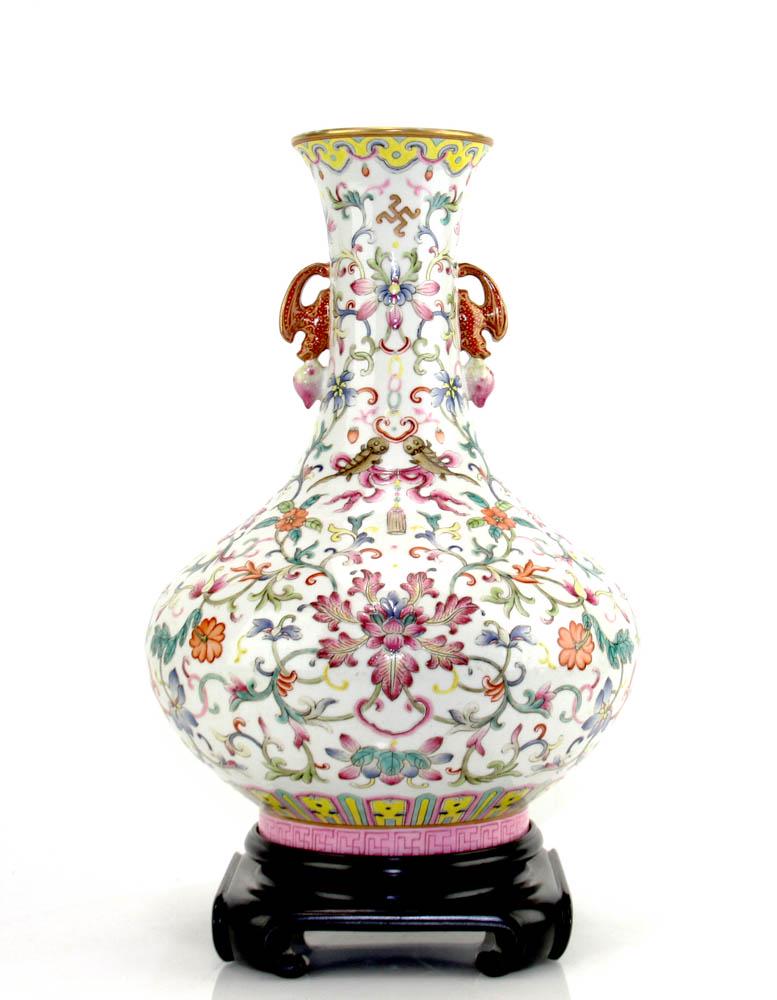 19thC Chinese Famille Rose Porcelain Vase: Porcelain vase, 19th century, with Bats holding peach-shaped double ears on either side of the bottle, the mouth rim of the bottle gilt and decorated with a Ruyi head ornament. The neck and body are d
