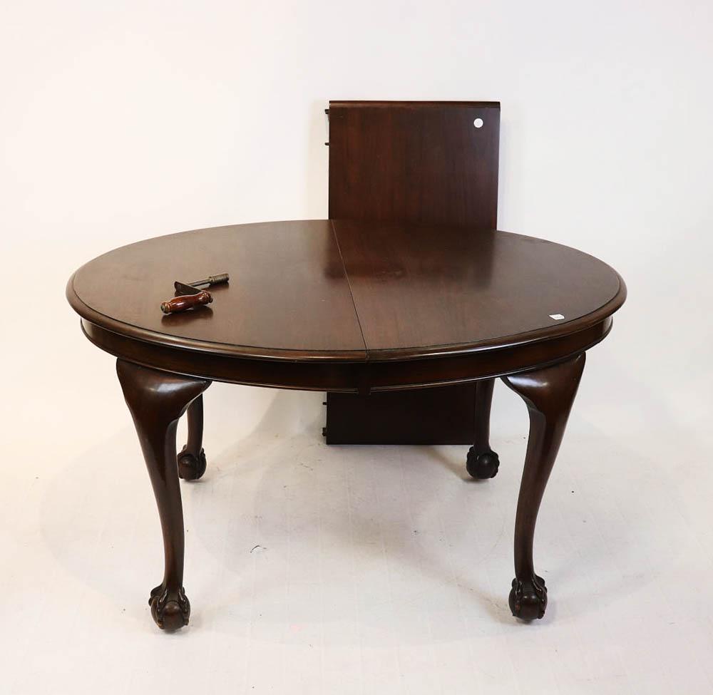 Mahogany Oval Ball-and-Claw Foot Dining Table: Mahogany oval dining table with ball-and-claw feet, 29" H x 52" W x 41" D, includes one 19 1/2" leaf.