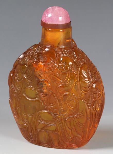 Chinese 19th C. Amber Snuff Bottle: Amber snuff bottle, China, 19th century, entirely carved with Buddhist Figures, 2 7/8"h.
