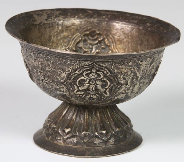 Tibetan 19th C. Oil Lamp: Oil lamp, Tibet, 19th century, decorated in relief with Buddhist emblems in cartouches, with a background of incised scrolling lotuses, the stem with lotus petal design, 2 5/8"h x 3 7/8"w.