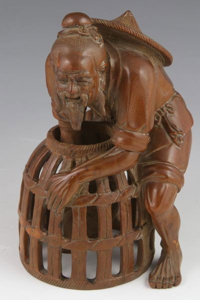Chinese 19th C. Boxwood Fisherman: Figure of an old fisherman, China, 19th century, with one arm reaching into the basket, carved from a single block of boxwood (huangyangmu), signed, 6 2/3"h.