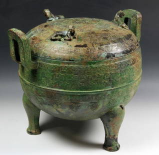 Chinese Warring States Period Bronze Vessel: Bronze "ding", China, Warring States Period, the compressed globular form incised with chi-dragons, the cover with three finials in the form of mythical beasts, with two straight loop handles, on trip