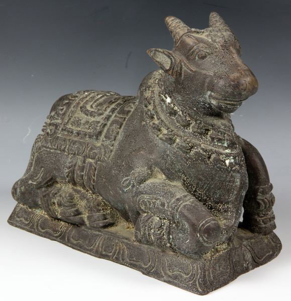 Bronze Cow: Bronze figurine, Southeast Asia, one of a recumbent cow, on base.