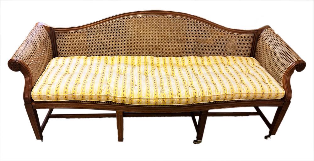Cane Sofa on Casters: Cane sofa on casters, 34" H x 82" W x approximately 27" D. Provenance: Concord, Massachusetts collection.
