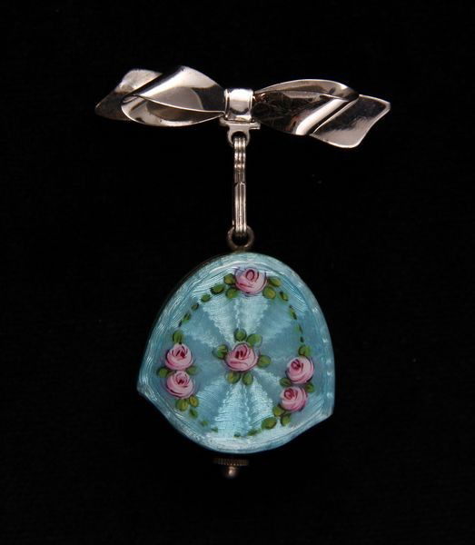 Bucherer Guilloche Enamel Pendant Watch: Ladies 'Bucherer' guilloche enamel and sterling pendant watch with sterling bow pin, watch is 1" x 1", 6 Troy oz. TW (including movement). Operational condition unknown.