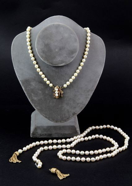2 Pearl and 14K Gold Necklaces: Two (2) pearl and 14K yellow gold necklaces to include: one (1) with ruby and pearl clasp, fifty-two (52) 6.0 to 6.5 mm pearls, 16 1/4"l; one (1) with tassel ends, (101) 7.0 to 7.5 mm semi baroque pea