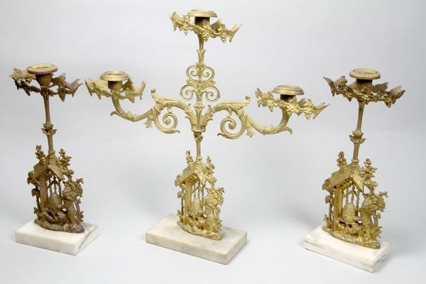 3 Piece Girandole Set: Three piece girandole set having bear and honeypot pattern, brass and marble, largest 17"h x 17 1/4"w.