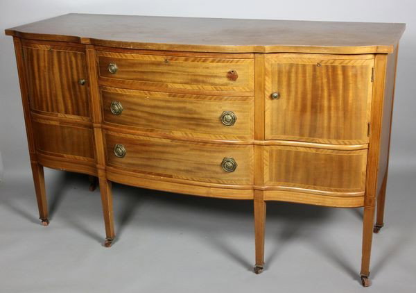 20th C. Hepplewhite Sideboard: Early 20th century Hepplewhite style mahogany sideboard with fruitwood stringing, two (2) center drawers flanked by compartments over one (1) long drawer, on casters, 39"h x 67"w x 25"d. Good conditio