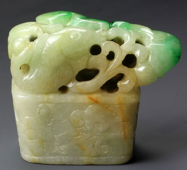 19th C. Chinese Jadeite Seal: Jadeite seal, China, 19th century, carved with scrolling floral motifs, surmounted with fish design, 1 3/4" x 21/8" x 1".