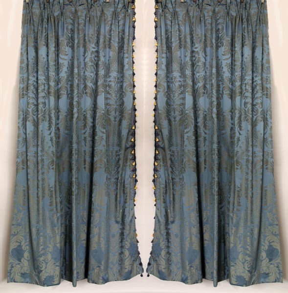 Pair of Blue Damask Fortuny Style Drapes: One pair of blue damask fortuny style pattern drapes, having matching cornice board, 102"l x 77"w (drapes), 16"h x 55"w x 10"d (cornice board). Two left panels.