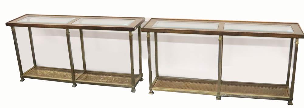 Pair of Brass and Wood Console Tables: Pair of brass and wood console tables with beveled glass top and rattan lower shelf, 27 3/4" H x 56 1/4" W x 15 1/2" D. Provenance: The Anthony Athanas Collection, from one of his celebrated restauran