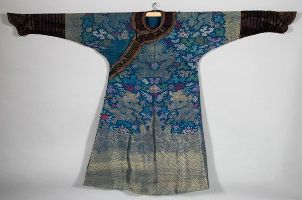 Chinese 19th/20th C. Dragon Robe: Dragon Robe, China, late 19th-early 20th century, of blue silk brocade, woven with dragons, longevity characters, crane and the eight Buddhist emblems, above rolling waves and li shui border, with hor