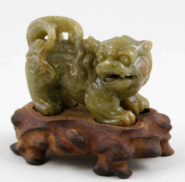 Chinese 19th C. Soapstone Foo Lion: Foo Lion, China, 19th century, soapstone, carved as crouching, on carved wood base, 1" x 2".