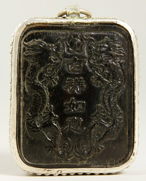 Chinese 19th C. Horn Pendent: Horn Pendent, China, 19th century, carved on one side with monkeys, the other with a pair of dragons flanking the phrase “ru yi ji chang” for well-wishes, mounted in silver frame, 2 1/4" x 1 7/8".
