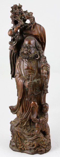 Chinese Wood Buddhist Figure: Buddhist Figure, China, wood, carved as standing, with a scroll in one hand and a staff with a gourd in the other, an attendant by his feet holding a shoe, 19 1/2".