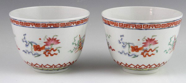 Pair of Chinese 19th C. Tea Bowls: Pair of Famille Rose Tea Bowls, China, 19th century, painted with the Eight Auspicious Buddhist emblems, with a ruyi border along the base, with six-character Guangxu mark on base, 2 1/2"h x 3 1/2"w.