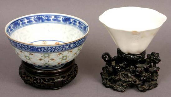 TWO ORIENTAL POTTERY BOWLS WOODEN STANDS: Two pieces of 20th Century signed oriental pottery bowls on carved wood stands, one porcelain libation cup 2 1/4" x 3 3/4" x 2", with rim chips and hair line cracks; one blue and white soft paste