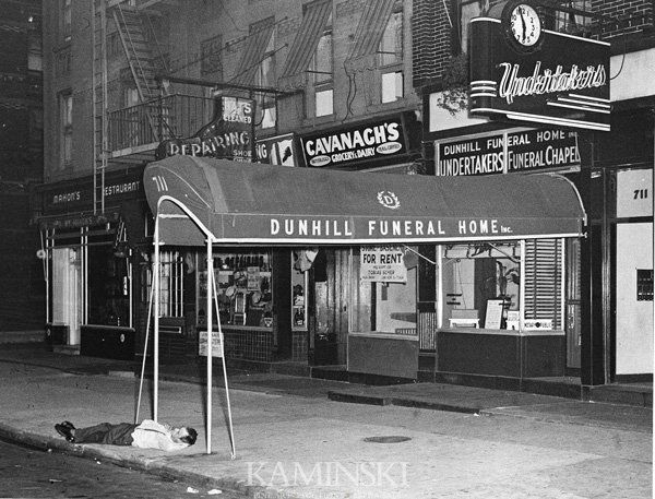 Weegee, Men Sleeping on Sidewalk, Photograph: Weegee (American 1899-1968), man sleeping on sidewalk in front of Dunhill Funeral Home, exhibition print, mid 1940s, 7 1/2"h x 9 1/2"w. Previously belonging to Joe Jasger, photograppher in Los Angeles