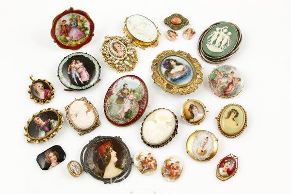 Collection of 22 Pins and Buttons: Collection of pins and buttons, painted and/or transferred portraits on porcelain in brass, two shell cameos, 22 total, largest is 2 1/4"l x 2"w.