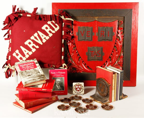 Collection of Harvard Memorabilia: Collection of Harvard University memorabilia to include 12 books, 8 piece copper coaster set, pair of bronze bookends 6 1/2"h x 5 3/4"w, 18" square pillow (minor moth damage), 27" x 27" carved oak pla