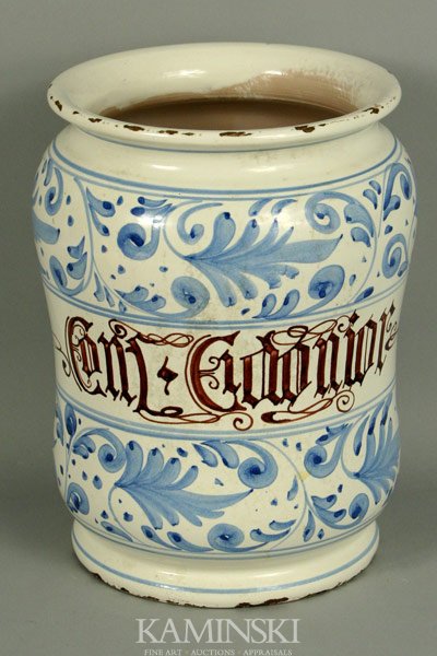 Italian Ceramic Albarello Jar: Italian ceramic albarello jar, blue scroll design, white ground with inscription, 10"h x 6 1/2"dia. Age chips on rim and base, minor abrasions.