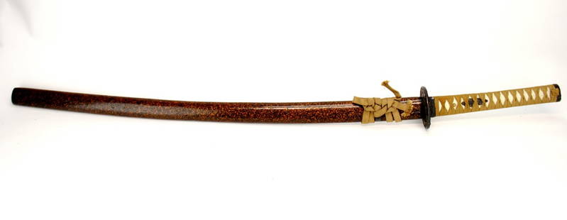 A Japanese Sword: A fine Japanese early 20th century sword with lacquered wood sheath. 41 inches Long.