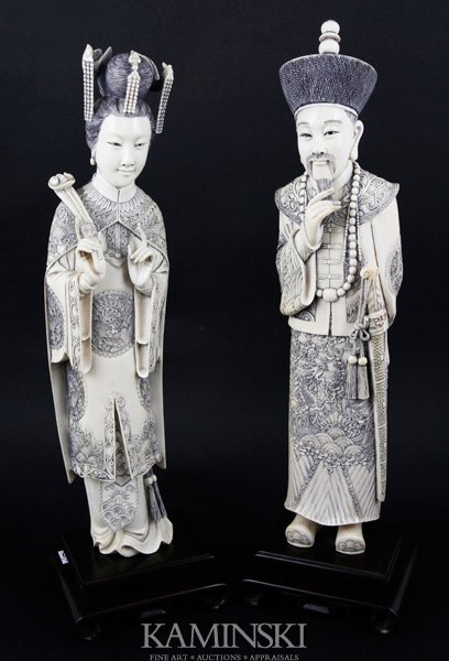 Exceptional Chinese Emporer and Empress: Pair of figures, China, possibly republic period, ivory, matching African elephant tusks, carved in the form of the Qianlong Emporer and his wife, having intricately carved robes, on rosewood stands, 