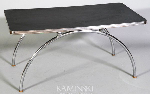 Weber Coffee Table: Kem Weber for Lloyd Loom, coffee table, arched chrome-plated steel legs and black laminate top, 16 1/2"h x 34"w x 18"d. Light scratching to top.