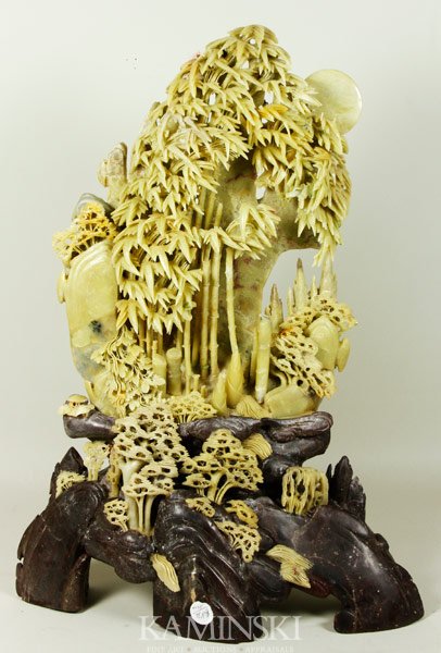 Chinese Stone Mountain: Stone mountain, China, pale green soapstone carved in the form of bamboo trees with contrasting grey rock, 24” x 17”.
