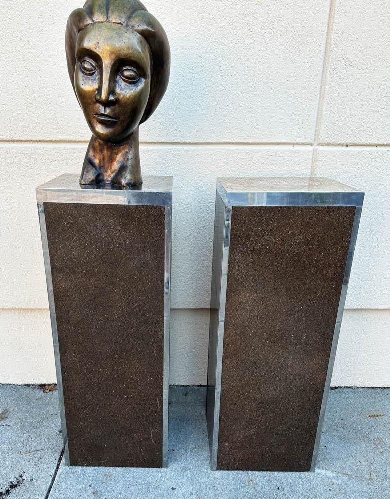 Pair of Jay Spectre Pedestals: Pair of Jay Spectre pedestals, stainless steel and brown speckled resin panels, also used as speakers, 40" H x 15" W x 13" D. Note: lot does not include pictured sculpture. Provenance: Boynton Beach,