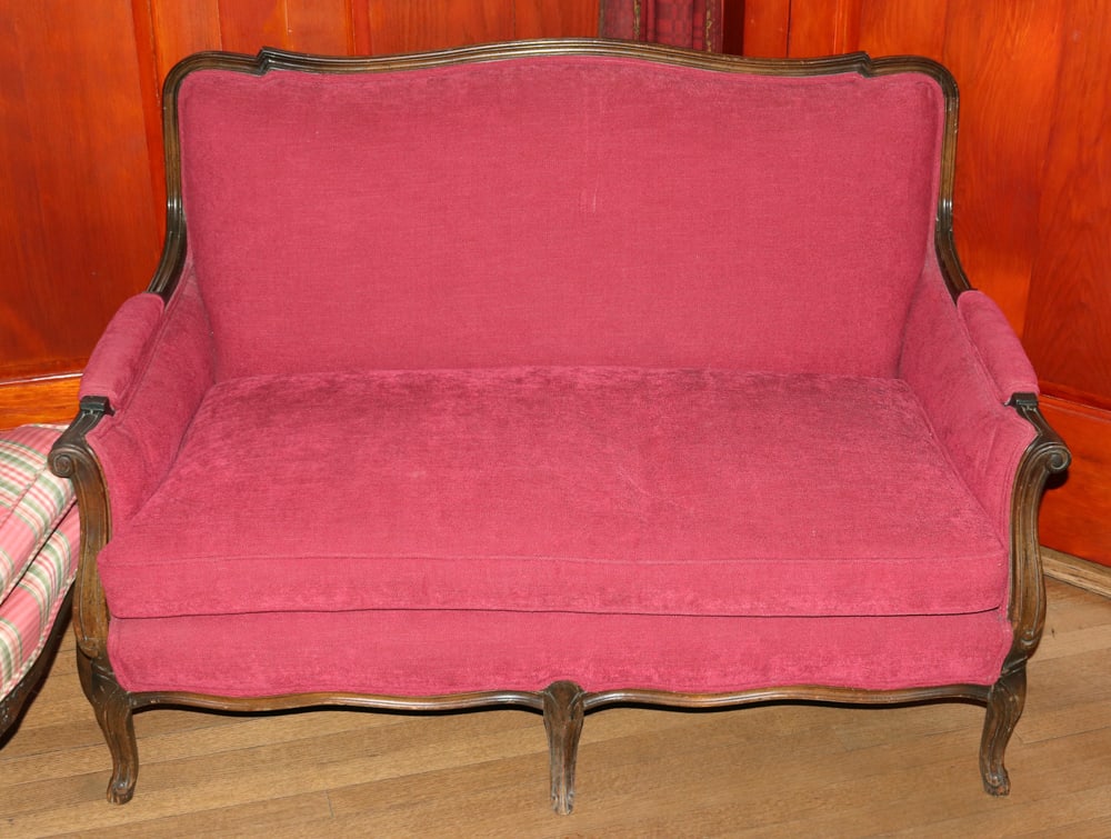 French-style Red-Upholstered Settee: French-style red-upholstered settee, 31" H x 49" W x 30" D. Good condition. Provenance: Wayside Estate, 118 McLain St., Bedford Corners, Mount Kisco, New York. PLEASE NOTE: Lot to be picked up from it